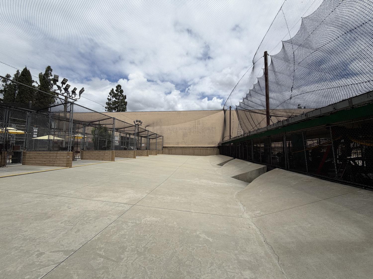 Home Run Park's wide-open outdoor batting cages with 30-foot netting against the sky in Anaheim