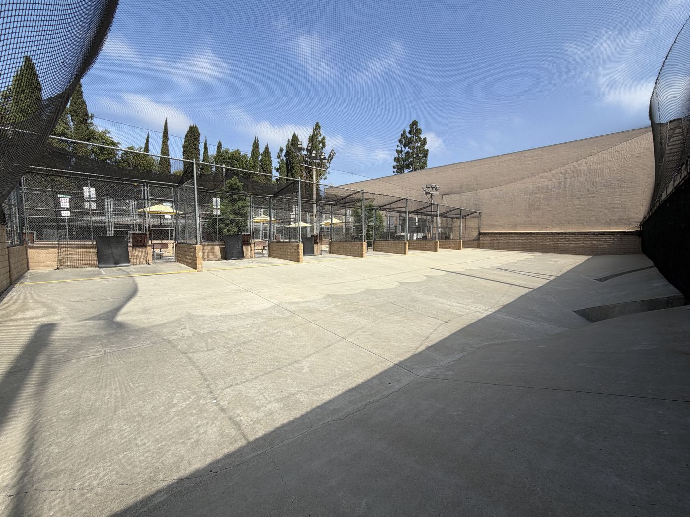 Panoramic view of the wide-open cages and net canopy with trees